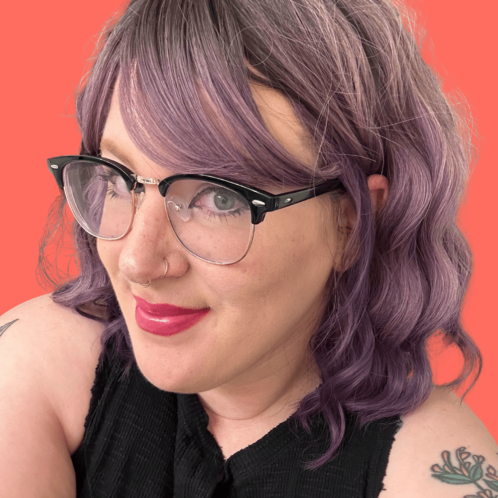 Photo of me on a coral background.